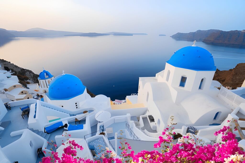 Discovering Santorini: A Journey Through Greece’s Most Iconic Island A breathtaking view of Santorini’s whitewashed houses with blue domes overlooking the Aegean Sea at sunset.