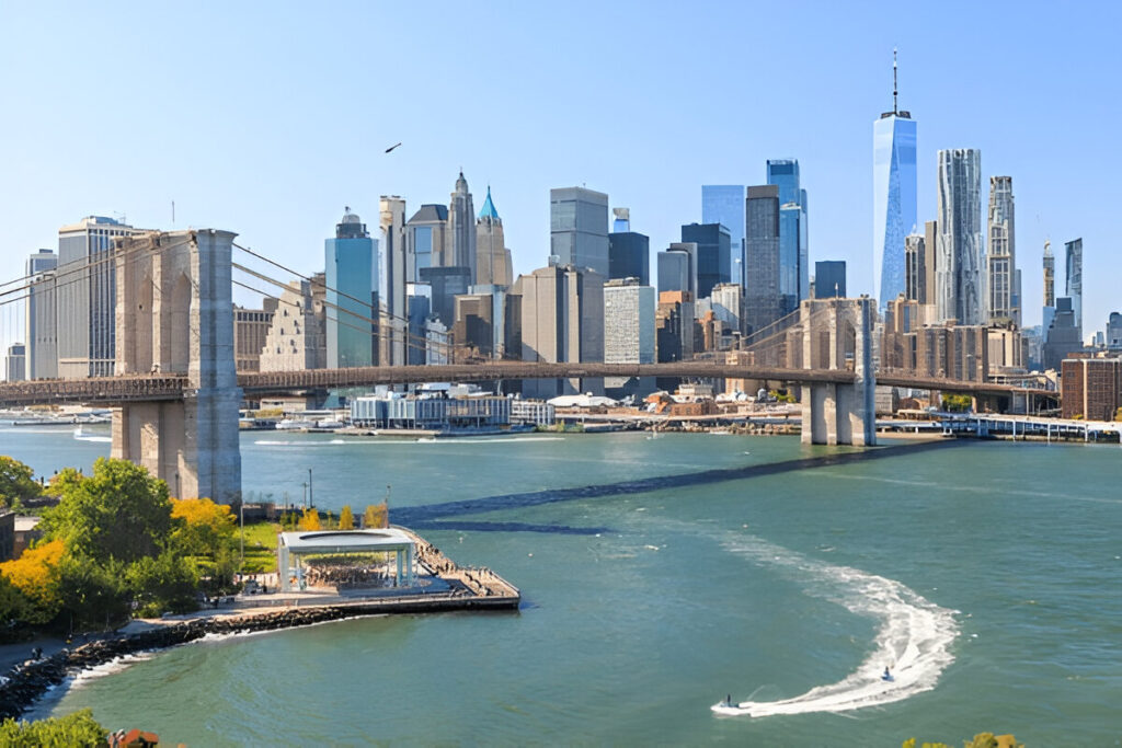 10 Of the Best East Coast Family Vacations and Destinations Family enjoying Central Park in New York City with the skyline in the background – best East Coast family vacation destination.