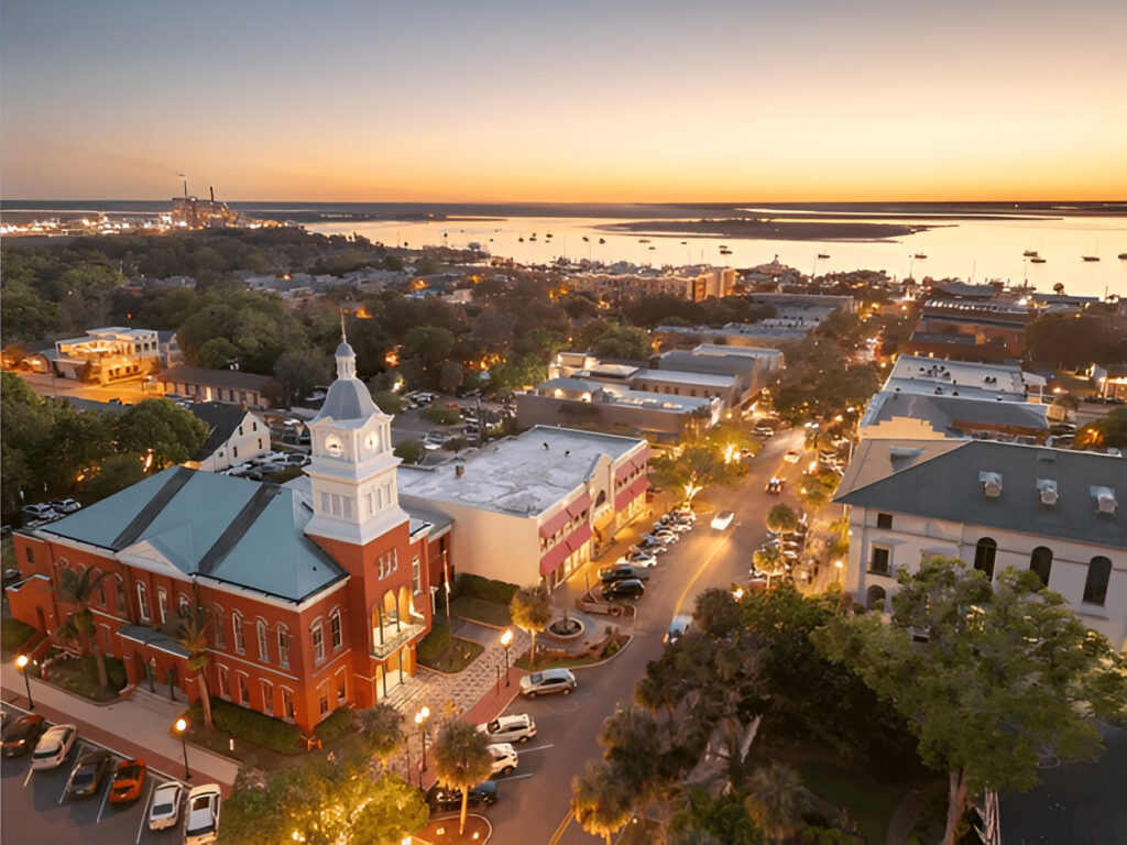 10 Of the Best East Coast Family Vacations and Destinations Fernandina Beach on Amelia Island with families relaxing on the shore peaceful East Coast beach destination